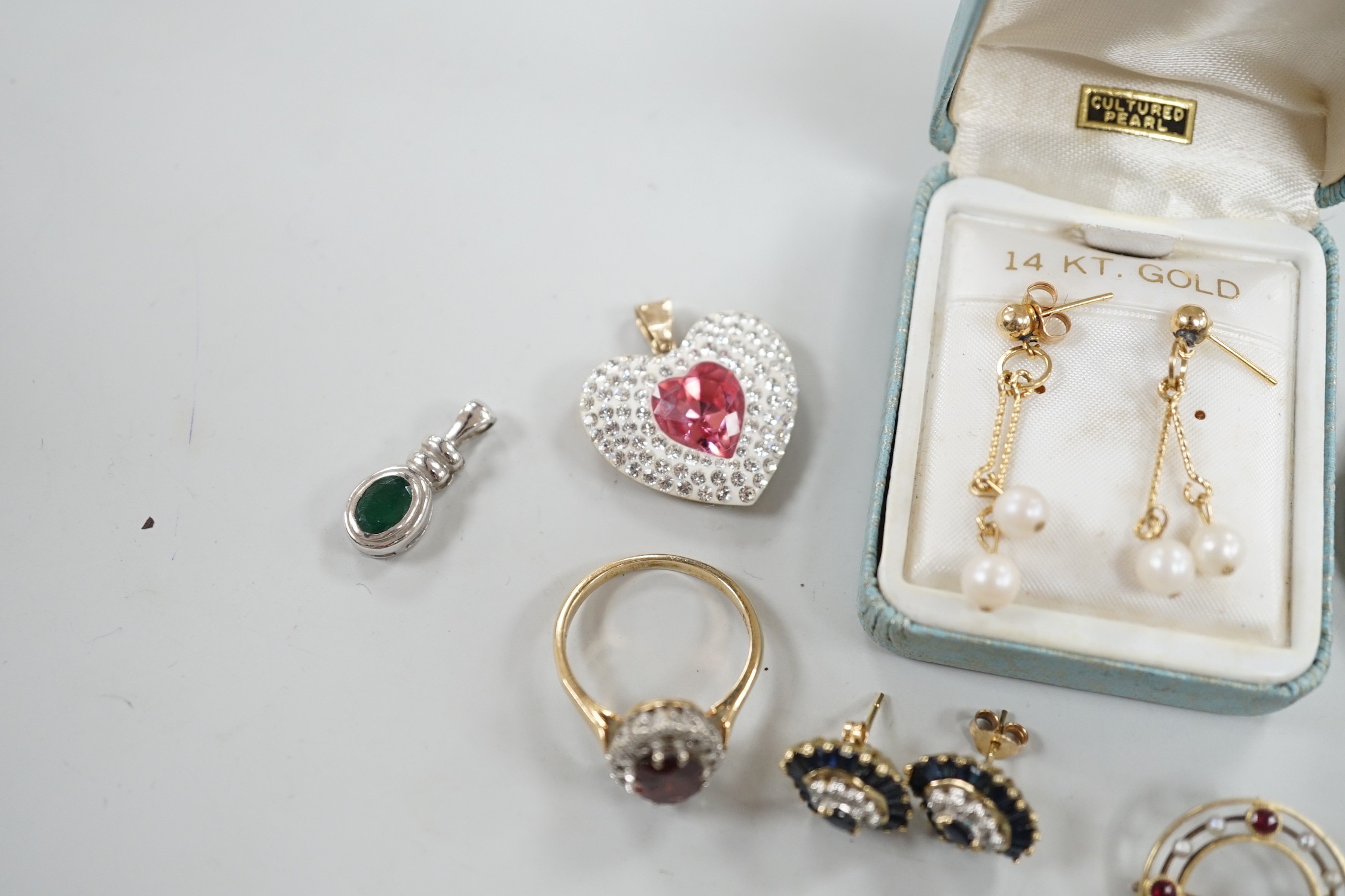 Mixed jewellery including two 9ct and gem set cluster rings and a 15ct, ruby and seed pearl set circular brooch, a yellow metal mounted oval cameo shell brooch, a pair of 9ct gold and gem set cluster ear studs, a 9ct whi